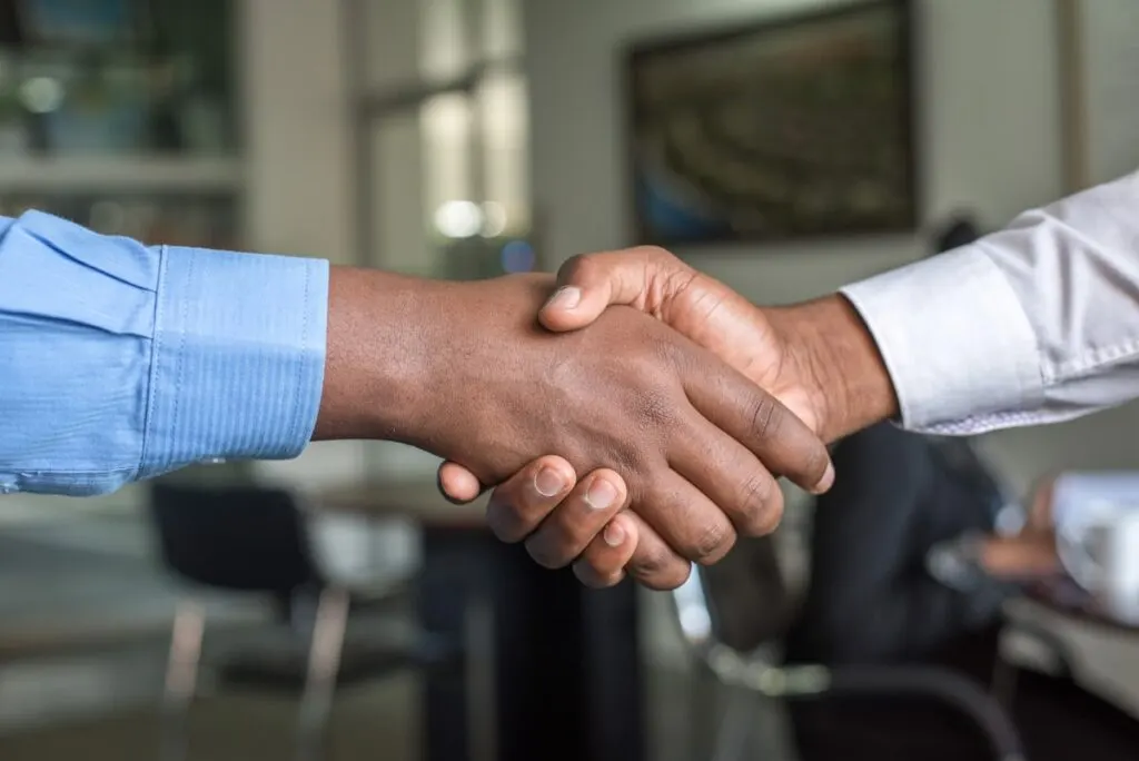 Handshake between a Dover Junk crew member and a happy customer after a junk removal job